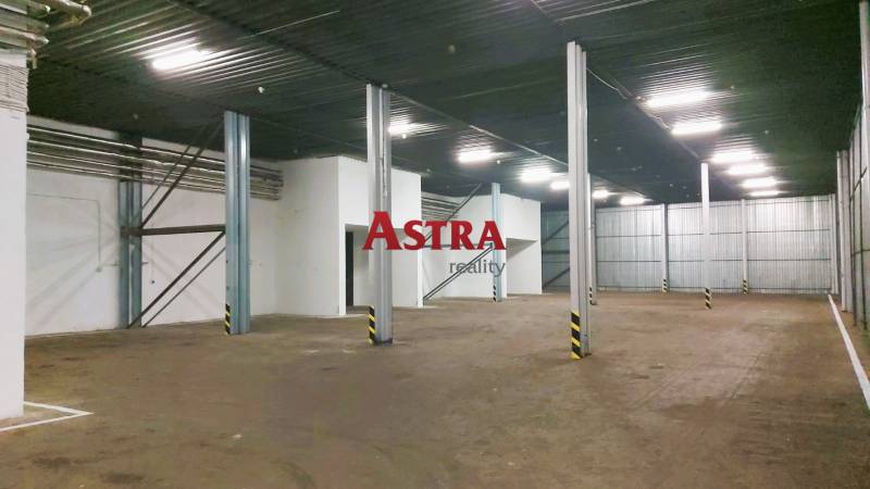 Uvnitř skladu jsou ocelové nosníky a betonová podlaha.