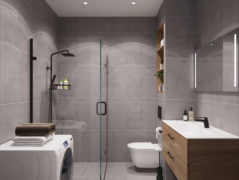 Koupelna se sprchovým koutem, umyvadlem a pračkou v 1-pokojovém bytě.