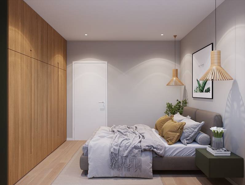 Ložnice v jednopokojovém bytě s postelí, rostlinou a dřevěným dekorem na podlaze.