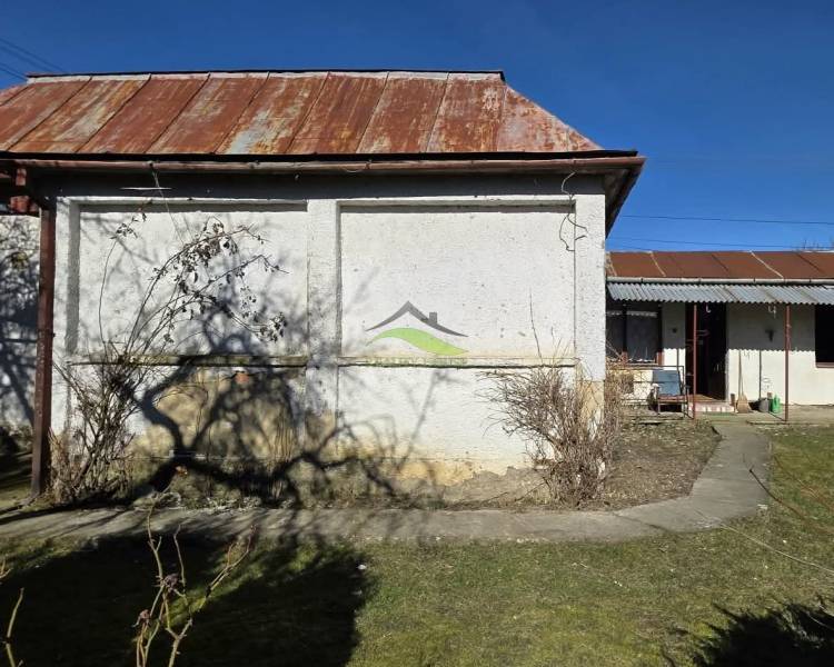 Rodinný dům v Pavlovcích nad Uhom s dvorem, střecha s rezavějícími plechy.