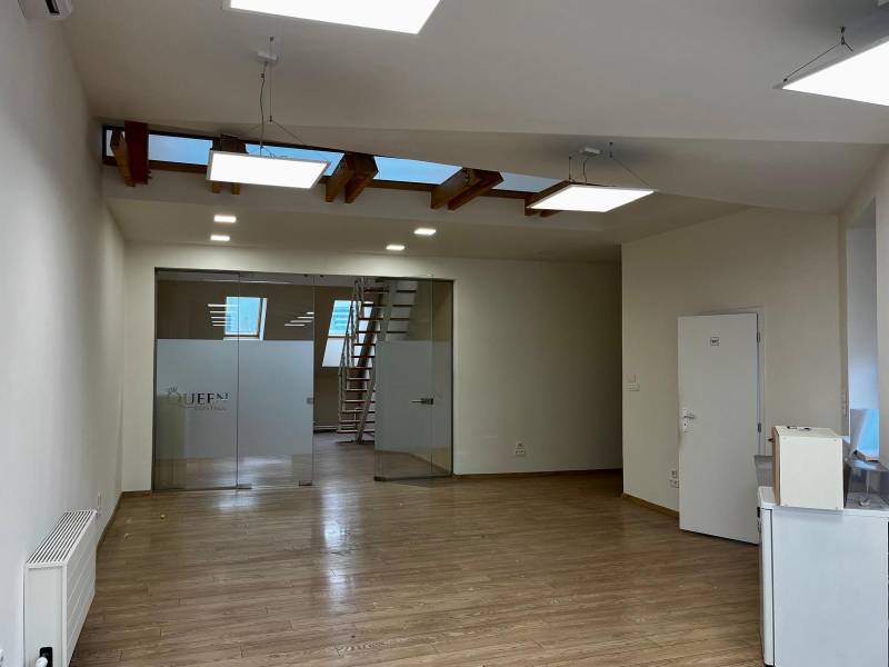 Kanceláře s podlahou s dřevěným dekorem, prosklené dveře a schody.