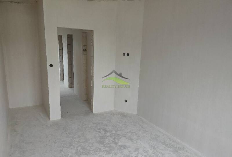 Bílá místnost s průchody v rodinném domě, připravená k dokončení.