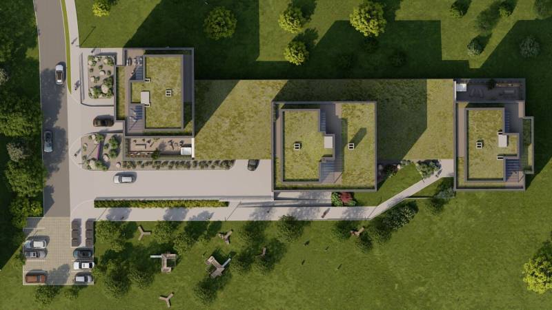 Letecký pohled na střechy a okolní park trojice budov na Suchoňově ulici v Popradu Jih.