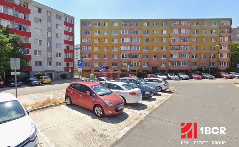 Parkoviště před bytovkami v Bratislavě - Rači s barevnými fasádami.