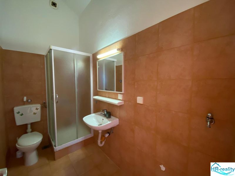 Koupelna v rekreačním apartmánu s umyvadlem a sprchovým koutem.