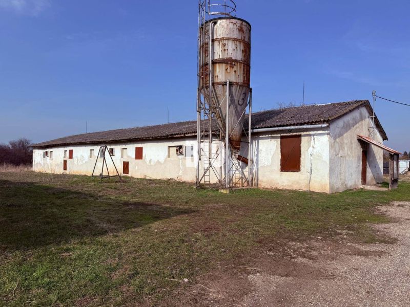 Výrobní prostory ve městě Turá s rozsáhlým dvorem a staršími budovami v pozadí.