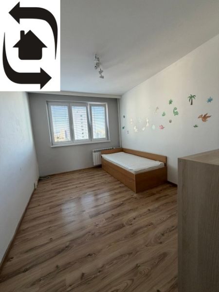 Dětský pokoj v 3-pokojovém bytě s postelí a podlahou s dřevěným dekorem.