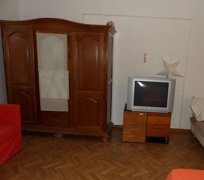 Pokoj v 2-pokojovém bytě s dřevěným nábytkem a podlahou s dřevěným dekorem.