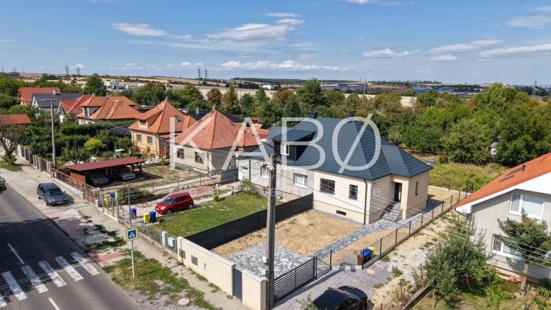 Rodinný dům na Trnavské ulici v Nitře obklopený zahradami a sousedními domy.