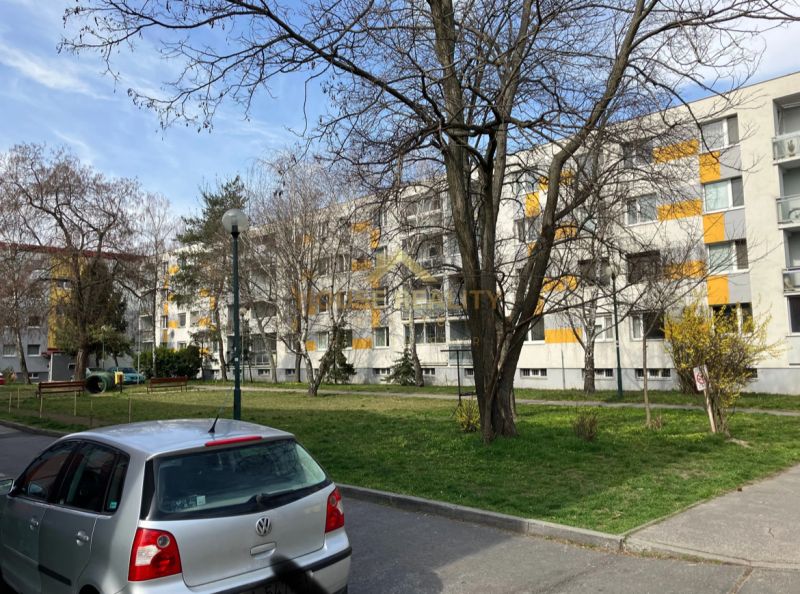 Auta parkující před bytovým domem s balkóny v Bratislavě - Ružinově, Starých zahradách.