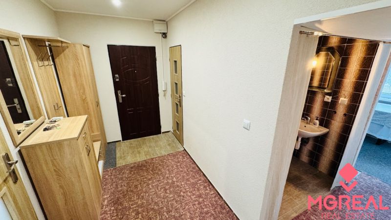 Chodba v 3-pokojovém bytě s vestavěnými skříněmi a umyvadlem s osvětlením.