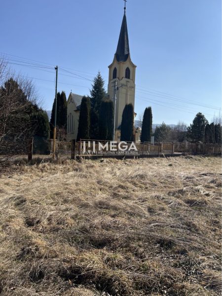 Pozemky - bydlení v Modré nad Cirochou se scenérií kostela.