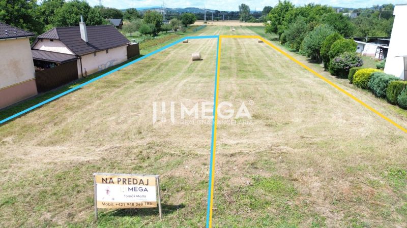Pozemky - bydlení v Jasenově se zemí rozdělenou barevnými liniemi a balíky slámy.