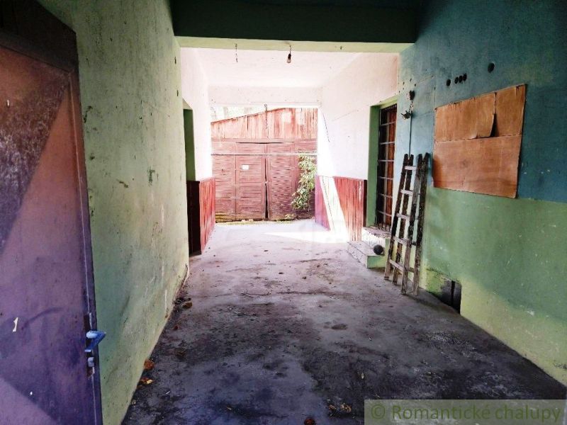 Obchodní prostory s otevřeným vstupem a betonovou podlahou, připravené na úpravy.